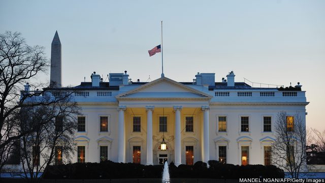 The US flag flies at half-staff above th